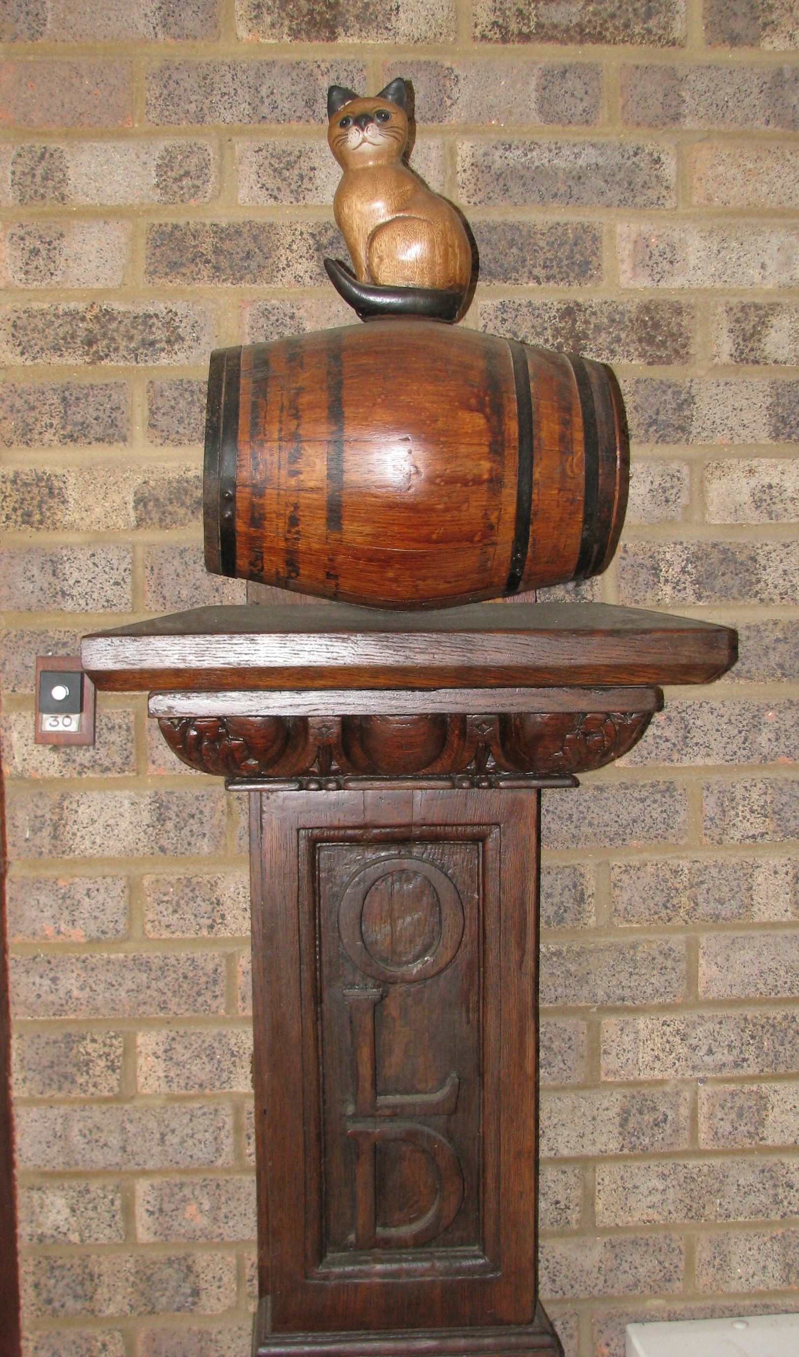 Miniature replica  of cat on remains of old post at Garrick Green